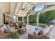 Relaxing covered patio featuring comfortable seating, ceiling fan, and tranquil views of lush greenery at 654 Cannon Rd, Sharpsburg, GA 30277