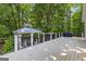 Large deck with a covered area, hot tub, and grill perfect for outdoor gatherings at 654 Cannon Rd, Sharpsburg, GA 30277