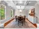 Formal dining room with coffered ceiling, large windows, and a stylish chandelier at 654 Cannon Rd, Sharpsburg, GA 30277