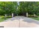 Private driveway with wrought iron gates and lush landscaping leading to the property at 654 Cannon Rd, Sharpsburg, GA 30277