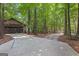 Long concrete driveway leading to a spacious detached garage surrounded by lush trees at 654 Cannon Rd, Sharpsburg, GA 30277