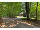 Scenic driveway surrounded by lush greenery leads to a charming home at 654 Cannon Rd, Sharpsburg, GA 30277