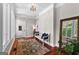Bright entryway with hardwood floors, a bench, area rug and beautiful natural light at 654 Cannon Rd, Sharpsburg, GA 30277