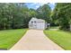 Beautiful white farmhouse-style home with a spacious driveway and well-manicured lawn at 654 Cannon Rd, Sharpsburg, GA 30277