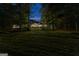 Home exterior at night with a grassy yard, lit windows, and a visible starry sky at 654 Cannon Rd, Sharpsburg, GA 30277
