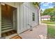 Exterior home entrance features stairs leading to the upper level and a concrete patio at 654 Cannon Rd, Sharpsburg, GA 30277