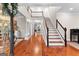 Spacious foyer with hardwood floors, staircase, and white columns leading to other rooms at 654 Cannon Rd, Sharpsburg, GA 30277