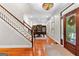 Elegant foyer with staircase, hardwood floors, and access to a home office at 654 Cannon Rd, Sharpsburg, GA 30277