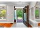 Inviting foyer featuring an open doorway, decorative wreath, and views of the landscaped front yard at 654 Cannon Rd, Sharpsburg, GA 30277