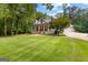 Charming two-story home with brick accents, a front porch, and beautiful landscaping in daylight at 654 Cannon Rd, Sharpsburg, GA 30277