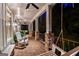 Inviting front porch featuring brick flooring, rocking chairs, ceiling fans, and a porch swing at 654 Cannon Rd, Sharpsburg, GA 30277