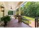 Spacious front porch with brick flooring, ceiling fan, and tranquil outdoor seating area at 654 Cannon Rd, Sharpsburg, GA 30277