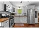 Well-lit kitchen featuring white cabinets, butcher block countertops, and stainless-steel appliances at 654 Cannon Rd, Sharpsburg, GA 30277