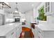 Gourmet kitchen features white cabinetry, stainless appliances, and copper apron sink at 654 Cannon Rd, Sharpsburg, GA 30277