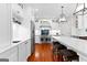 Modern kitchen features white cabinets, stainless appliances, and spacious island with seating at 654 Cannon Rd, Sharpsburg, GA 30277
