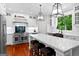 Modern kitchen features white cabinets, stainless appliances, and spacious island with seating at 654 Cannon Rd, Sharpsburg, GA 30277