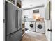 Well-lit laundry room with stainless steel appliances and ample storage at 654 Cannon Rd, Sharpsburg, GA 30277