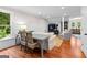 Cozy living room with hardwood floors, modern wainscoting, a plush couch, and a charming reading corner at 654 Cannon Rd, Sharpsburg, GA 30277