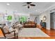 Spacious living room with hardwood floors, leather sofa, and views of the breakfast nook at 654 Cannon Rd, Sharpsburg, GA 30277