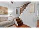 Cozy living room with white paneled walls and rich hardwood floors leading to a staircase at 654 Cannon Rd, Sharpsburg, GA 30277