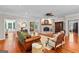 Cozy living room with brick fireplace, hardwood floors, and comfortable seating at 654 Cannon Rd, Sharpsburg, GA 30277