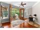 Open french doors lead to a spacious back porch from the living room at 654 Cannon Rd, Sharpsburg, GA 30277