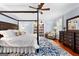 Comfortable main bedroom suite with four-poster bed and built-in bookshelves at 654 Cannon Rd, Sharpsburg, GA 30277