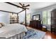Comfortable main bedroom suite with four-poster bed and built-in bookshelves at 654 Cannon Rd, Sharpsburg, GA 30277