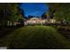Stunning rear exterior view with a large lawn and covered patio, perfect for enjoying starry nights at 654 Cannon Rd, Sharpsburg, GA 30277