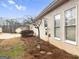 Home exterior is painted with neutral colors with professional landscaping around the house at 9135 Woodhaven Way, Mcdonough, GA 30253