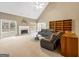 Cozy living room featuring a fireplace, mantel, large windows, and comfortable seating for relaxation at 9135 Woodhaven Way, Mcdonough, GA 30253