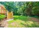 Landscaped backyard featuring a new deck, stairs, mature trees, and lush lawn at 70 Sylvia Cir, Covington, GA 30016