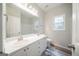 Bright bathroom features a double vanity, large mirror and natural light from a window at 70 Sylvia Cir, Covington, GA 30016
