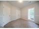 Carpeted bedroom features a double door closet and a sunlit window at 70 Sylvia Cir, Covington, GA 30016