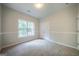 Carpeted bedroom has a double door closet and natural light from one window at 70 Sylvia Cir, Covington, GA 30016