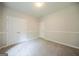 Carpeted bedroom with a double door closet and natural light from one window at 70 Sylvia Cir, Covington, GA 30016