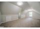 Bonus room under the eaves features neutral carpet and paint plus a window at 70 Sylvia Cir, Covington, GA 30016