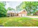 Well-maintained brick home with a two-car garage, manicured lawn, and mature landscaping at 70 Sylvia Cir, Covington, GA 30016