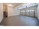 Spacious two car garage with smooth concrete floors, two openers, and white painted walls at 70 Sylvia Cir, Covington, GA 30016