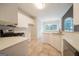 Light and airy kitchen boasting white cabinetry, quartz countertops, and tile flooring at 70 Sylvia Cir, Covington, GA 30016