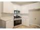 A modern kitchen with stainless steel appliances, white cabinets and quartz countertops at 70 Sylvia Cir, Covington, GA 30016