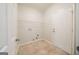 Functional laundry room with tile flooring and a wire shelf for storage at 70 Sylvia Cir, Covington, GA 30016