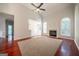 Bright living room with fireplace, ceiling fan, hardwood floors, and large windows at 70 Sylvia Cir, Covington, GA 30016