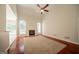 Spacious living room featuring hardwood floors, a fireplace, and large windows at 70 Sylvia Cir, Covington, GA 30016