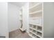 Walk-in closet features custom shelving and cabinets for optimal storage at 70 Sylvia Cir, Covington, GA 30016