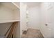 Well-organized walk-in closet features custom shelving with neutral carpet at 70 Sylvia Cir, Covington, GA 30016