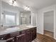 Vanity in the ensuite bath includes dual sinks, granite counters, and plenty of storage at 789 Galveston Way, Mcdonough, GA 30253