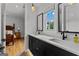 Bathroom boasts double sinks, sleek black hardware and access to bedroom at 185 Central Ave, Fayetteville, GA 30214