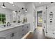This bright bathroom features a standalone tub, double vanity, walk-in glass shower, and marble backsplash at 185 Central Ave, Fayetteville, GA 30214