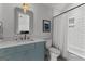Stylish bathroom featuring blue vanity, modern mirror, and tub-shower combination with white subway tile at 185 Central Ave, Fayetteville, GA 30214